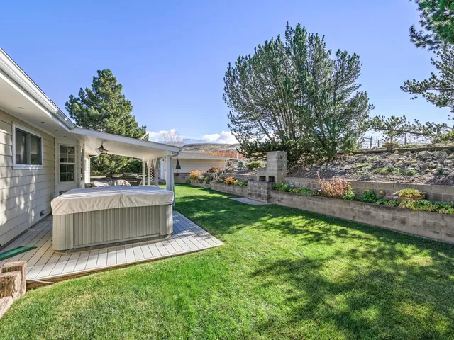 a view of a house with a yard and sitting area