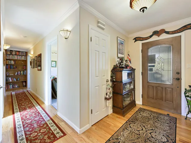 a kitchen with stainless steel appliances granite countertop a stove and white cabinets