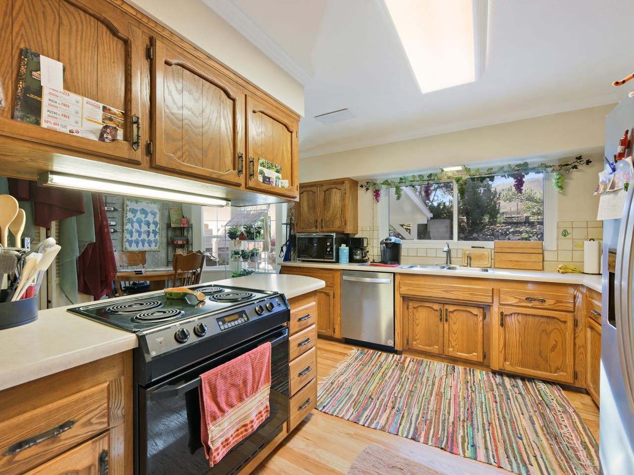 3697 F Road Palisade, CO 81526 - Photo 4 of 40 a kitchen with stainless steel appliances granite countertop a stove and white cabinets