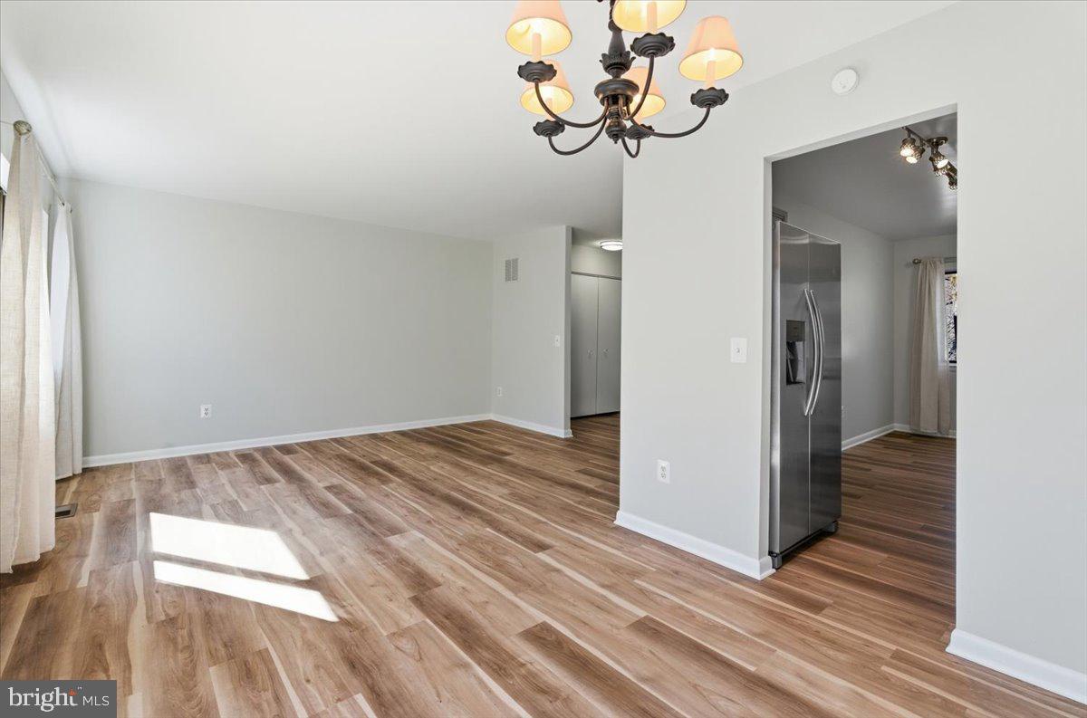 11919 Barrel Cooper Court Reston, VA 20191 - Photo 11 of 39 a view of a room with wooden floor and ceiling fan