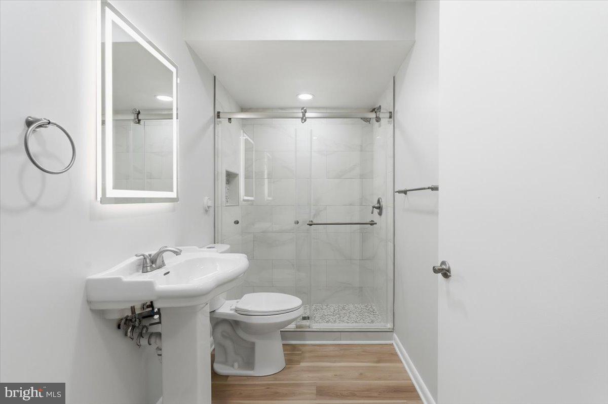 11919 Barrel Cooper Court Reston, VA 20191 - Photo 32 of 39 a bathroom with a sink toilet and shower