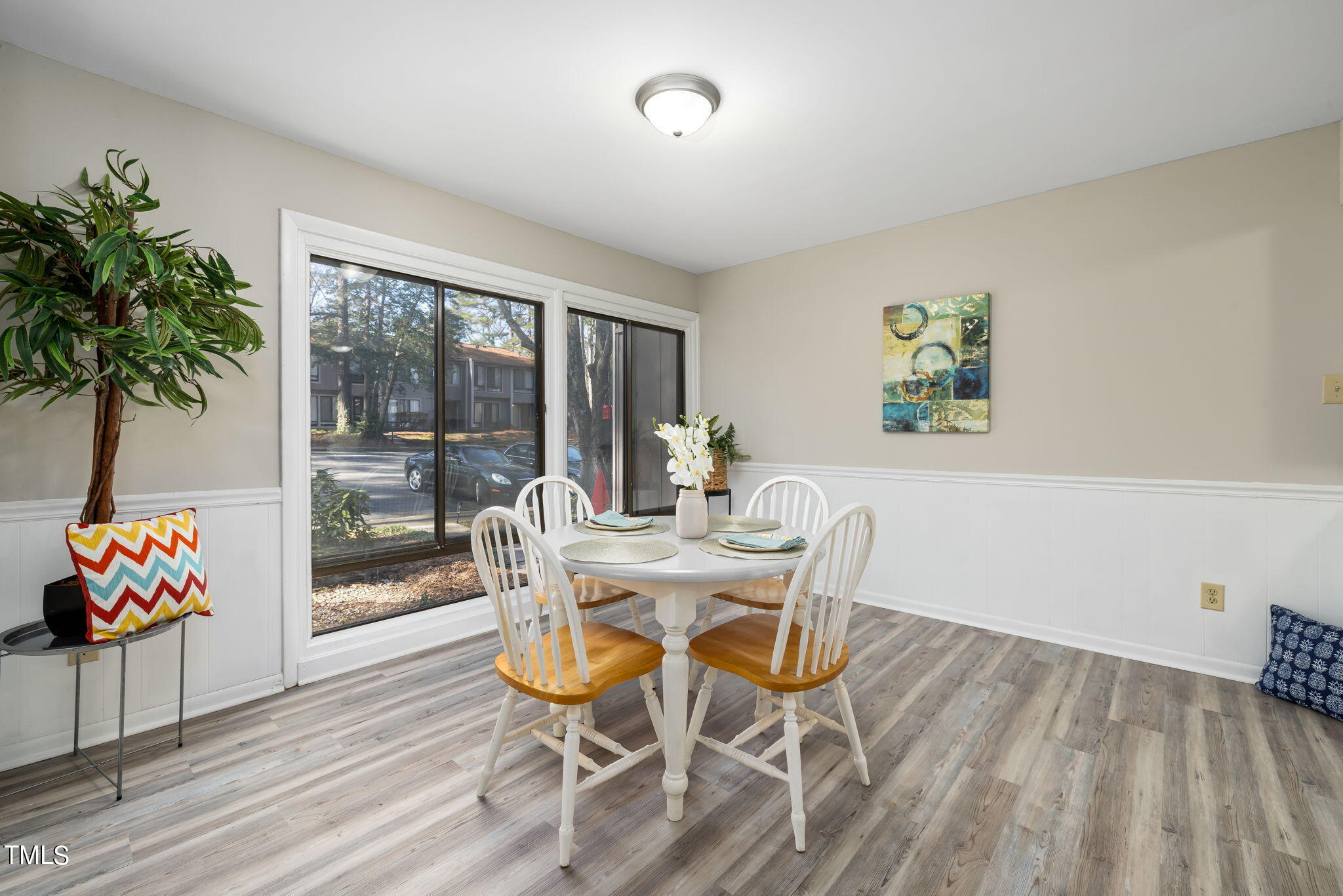 1728 Quail Ridge Road Raleigh, NC 27609 - Photo 6 of 38 a view of a dining room with furniture a livingroom and wooden floor
