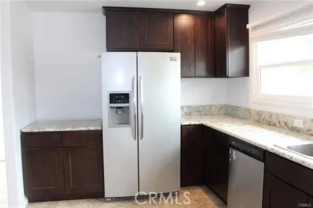 a kitchen with a refrigerator and a sink