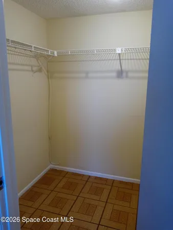 a bedroom with furniture and a book shelf