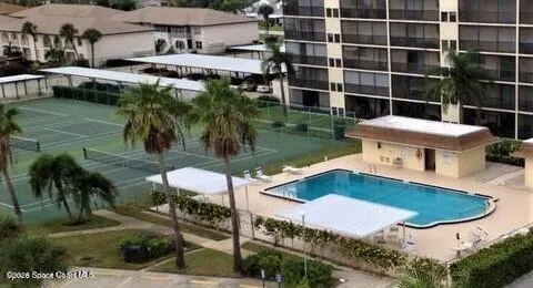 a view of a swimming pool with an outdoor seating and a garden