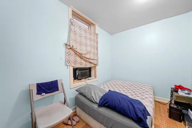 a bedroom with a bed and a fireplace