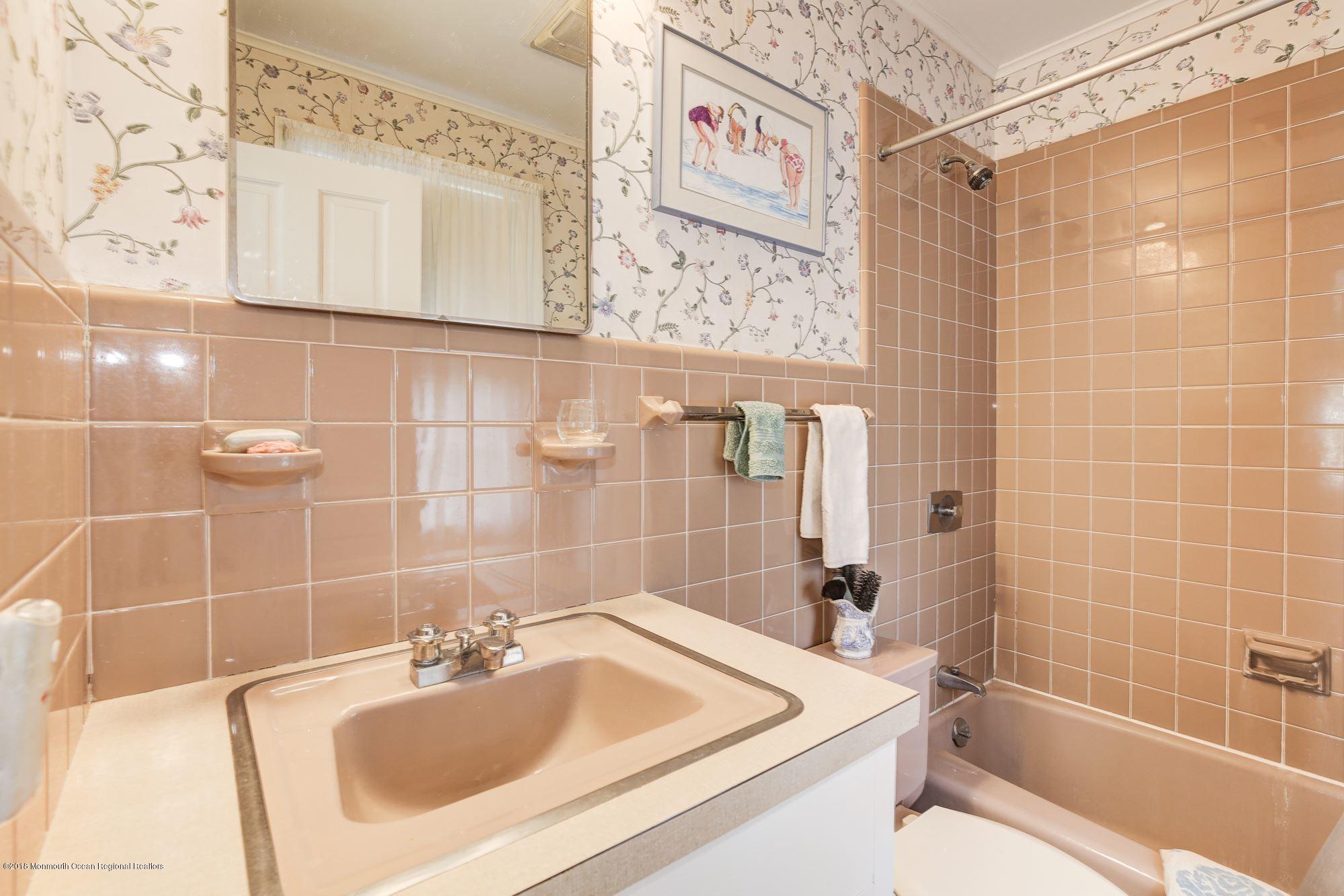 19 Tilton Road Middletown, NJ 07748 - Photo 13 of 26 a bathroom with a sink a toilet and shower