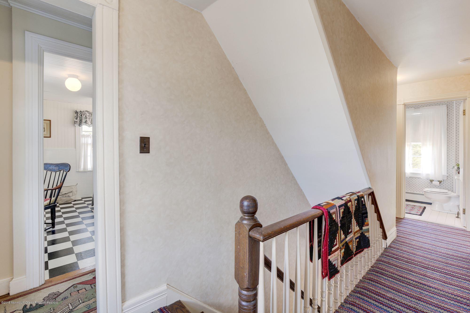 19 Tilton Road Middletown, NJ 07748 - Photo 14 of 26 a view of a hallway with wooden floor and staircase