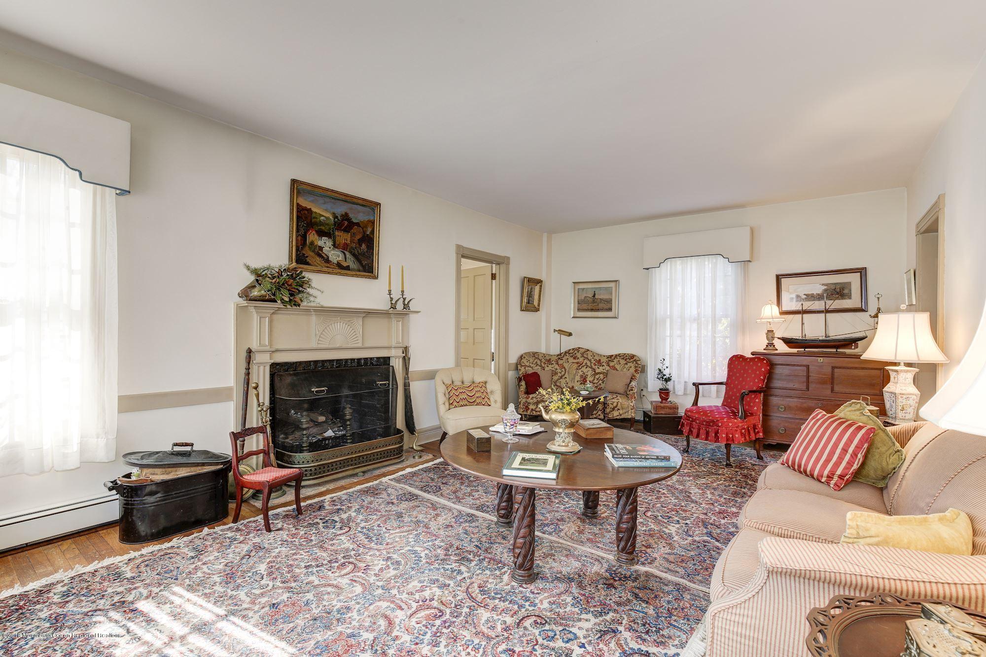19 Tilton Road Middletown, NJ 07748 - Photo 3 of 26 a living room with furniture a rug a fireplace and a window