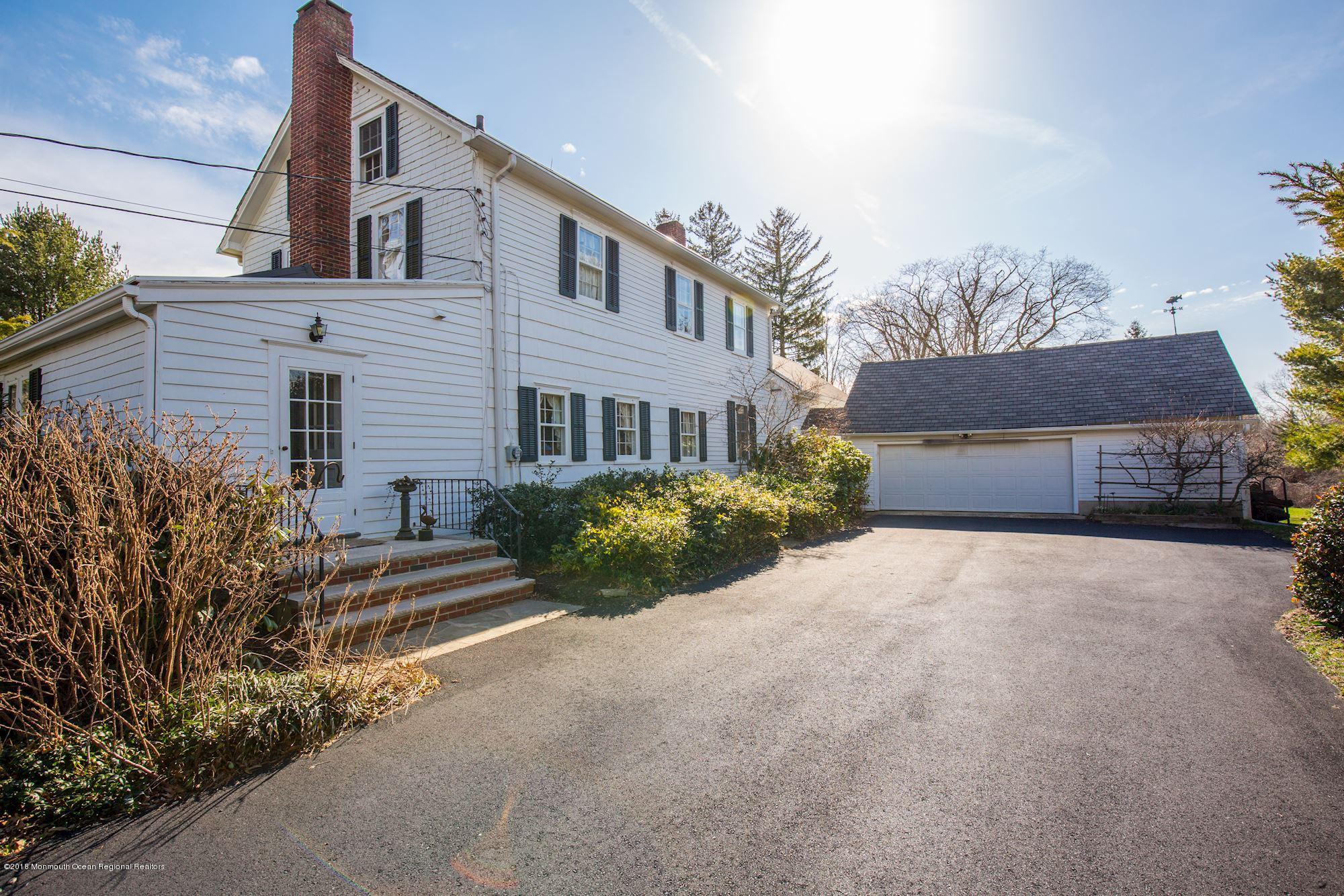 19 Tilton Road Middletown, NJ 07748 - Photo 23 of 26 a front view of a house with a yard and garage