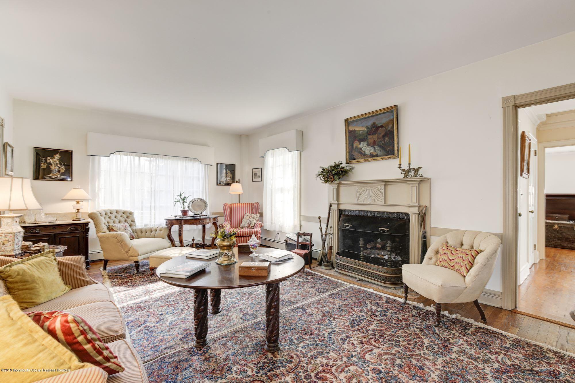 19 Tilton Road Middletown, NJ 07748 - Photo 4 of 26 a living room with furniture a fireplace and a table