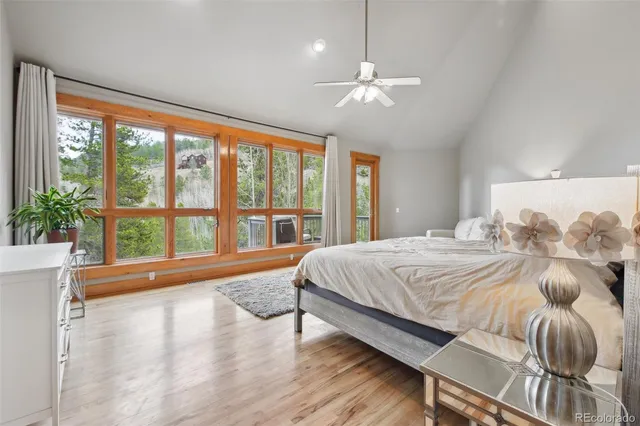a spacious bedroom with a large bed and a large window