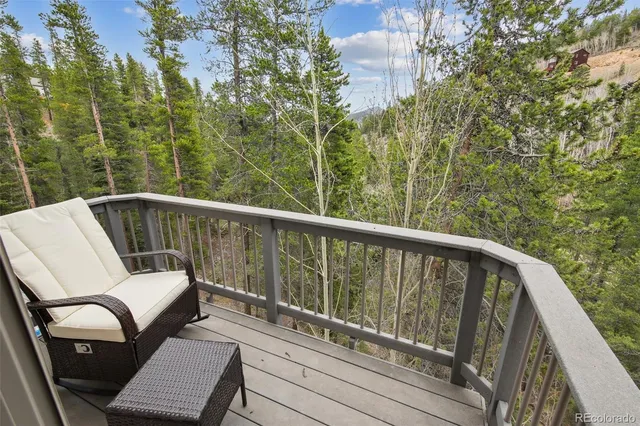 a view of a chair and table on the balcony