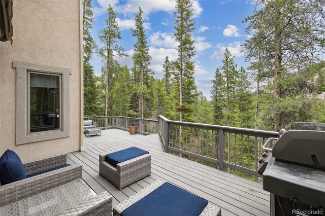 a balcony with furniture and wooden floor