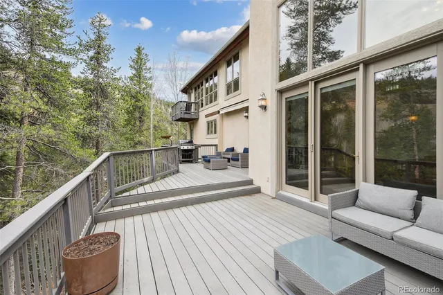 a balcony with table and outdoor seating