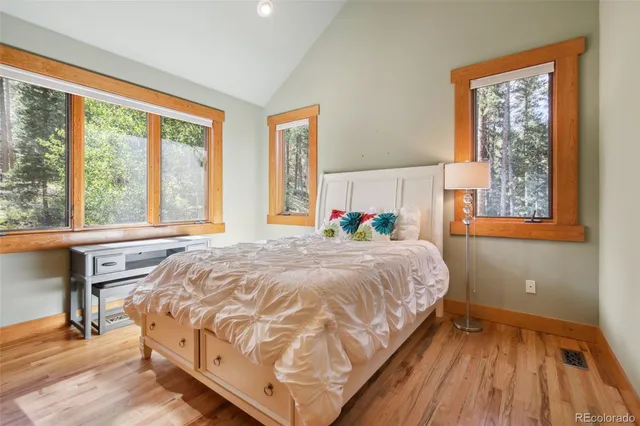 a bed sitting in a bedroom next to a window