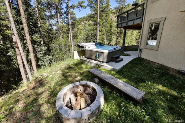 an aerial view of a house with garden space and sitting area