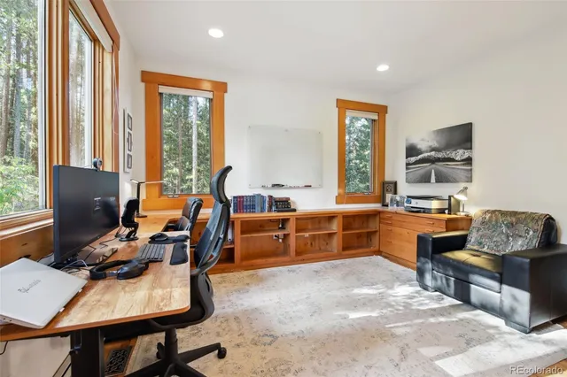 a room with furniture a desk and chair with windows