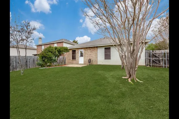 a view of a house with yard and a tree