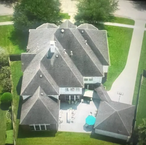 a view of a dining room with furniture and a chandelier
