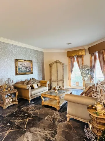 a dining room with furniture a chandelier and wooden floor