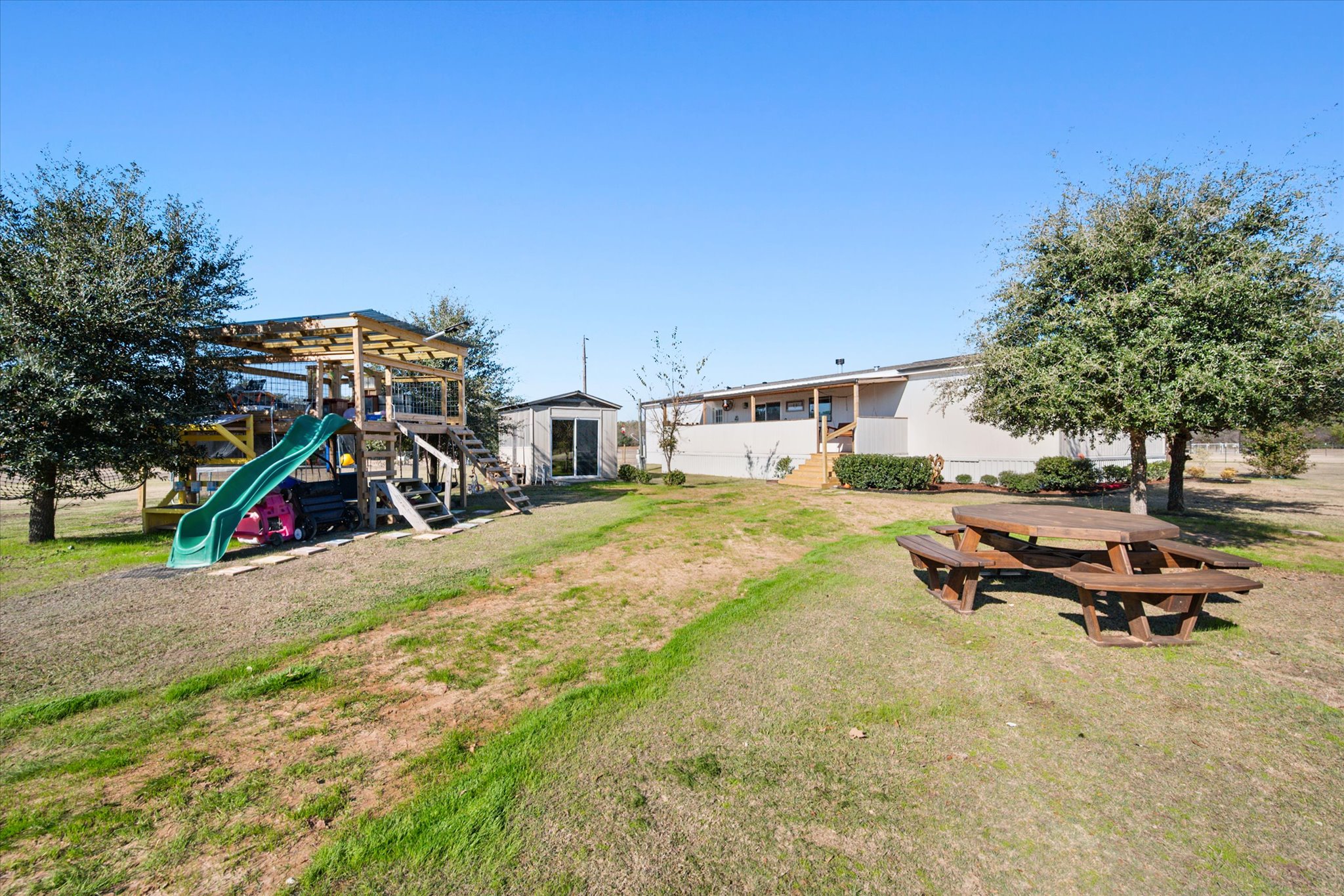 16857 Fm 639 Road East Purdon, TX 76679 - Photo 3 of 38 View of grassy yard with a playground and an outbuilding