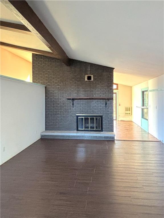 1568 Pulaski Mercer Road Mercer, PA 16137 - Photo 7 of 18 a view of empty room with wooden floor and fireplace