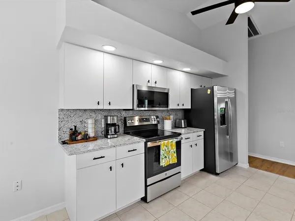 a kitchen with stainless steel appliances a stove microwave and refrigerator