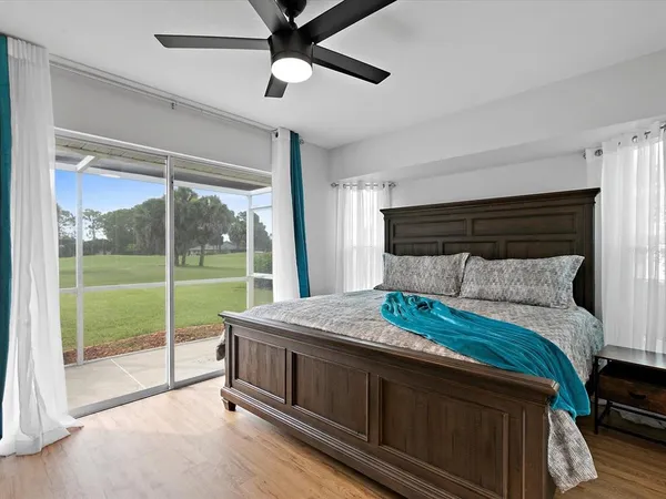 a bedroom with a bed and a view of balcony