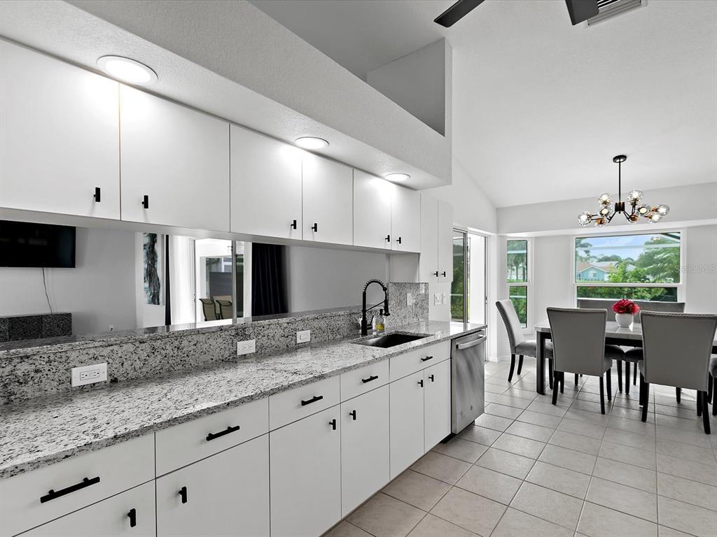 39 Long Meadow Court Rotonda West, FL 33947 - Photo 9 of 30 a large kitchen with kitchen island granite countertop a table and chairs