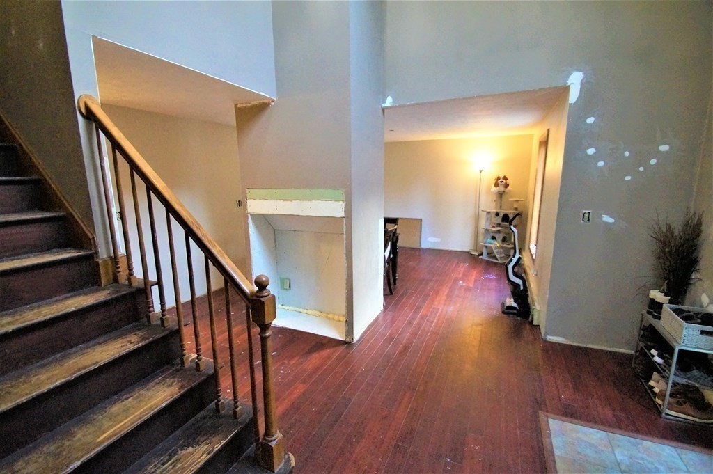 4 Hickory Ridge, Unit 4 Raymond, NH 03077 - Photo 12 of 22 a view of a hallway with wooden floor and staircase