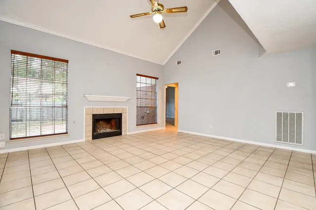 a view of an empty room with a fireplace and a window