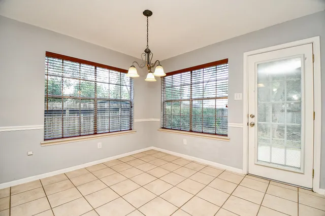 a bedroom with a balcony a bed and a flat screen tv