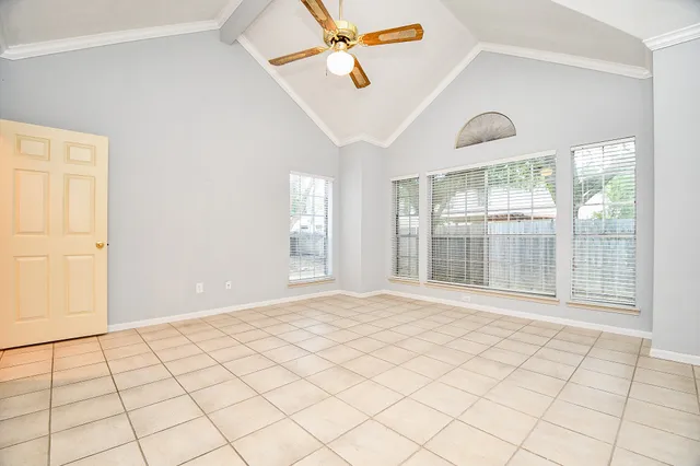 a view of kitchen with granite countertop cabinets and window