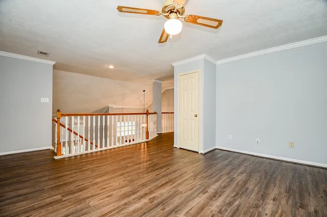 a bedroom with bed and paintings on the wall