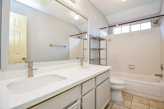 a white toilet sitting next to a white sink