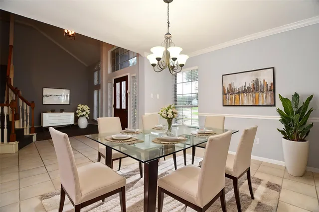 a view of a dining room with furniture wooden floor and a chandelier