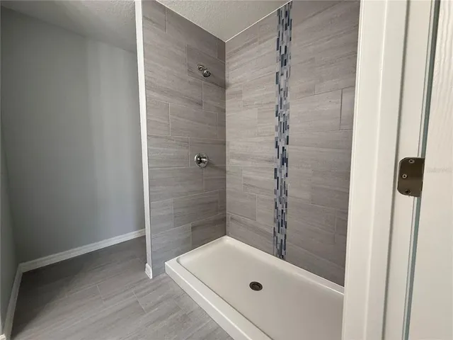 a bathroom with a tub and shower
