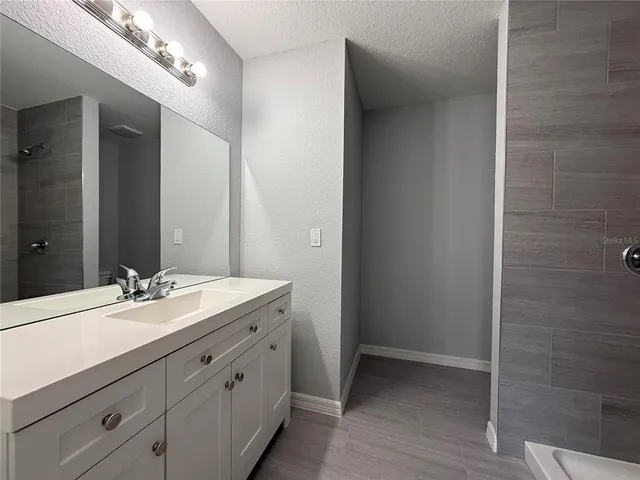 a bathroom with a double vanity sink and a mirror