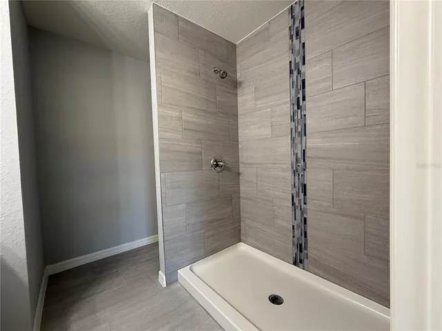 a bathroom with a tub and shower