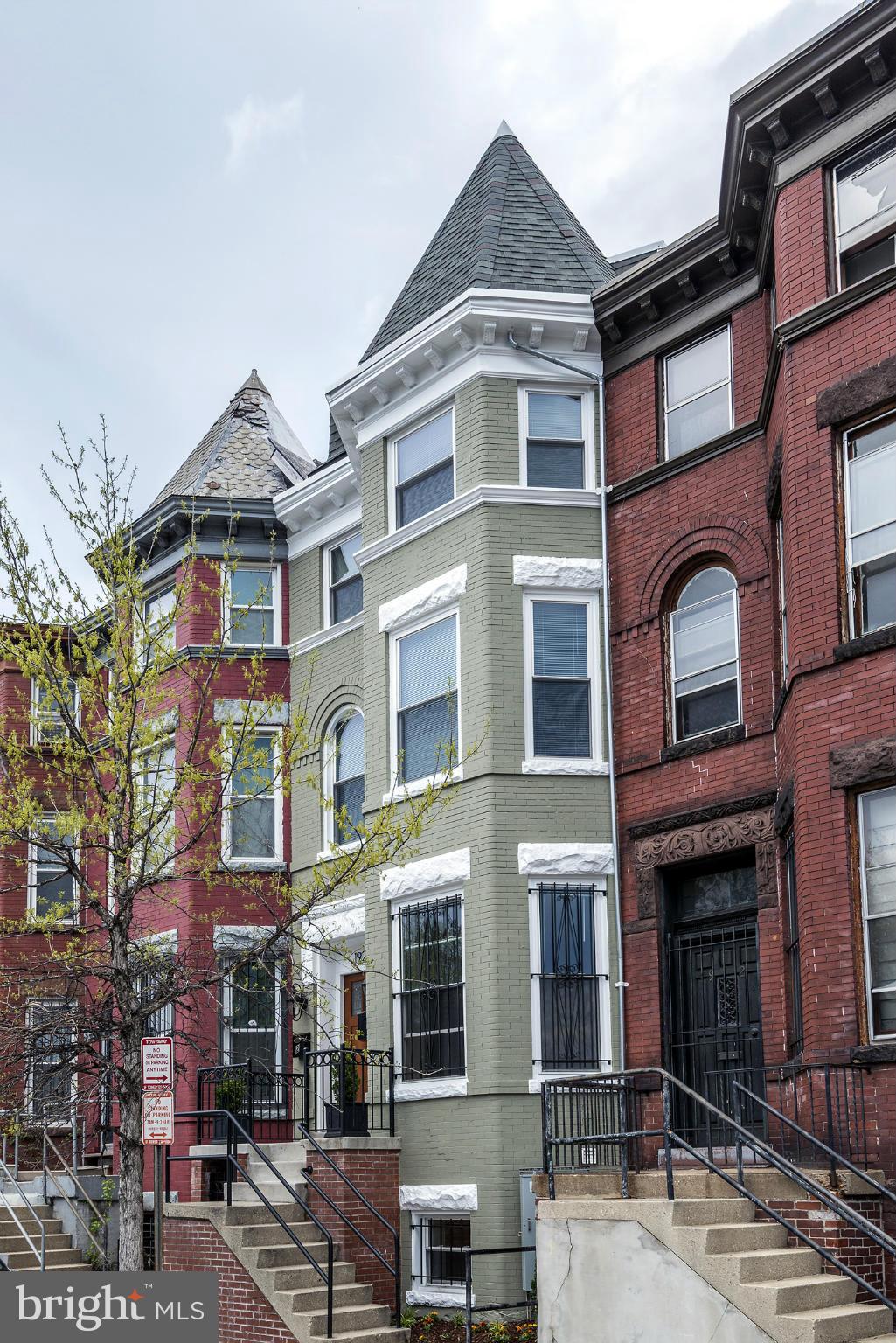 a front view of a residential apartment building with a yard