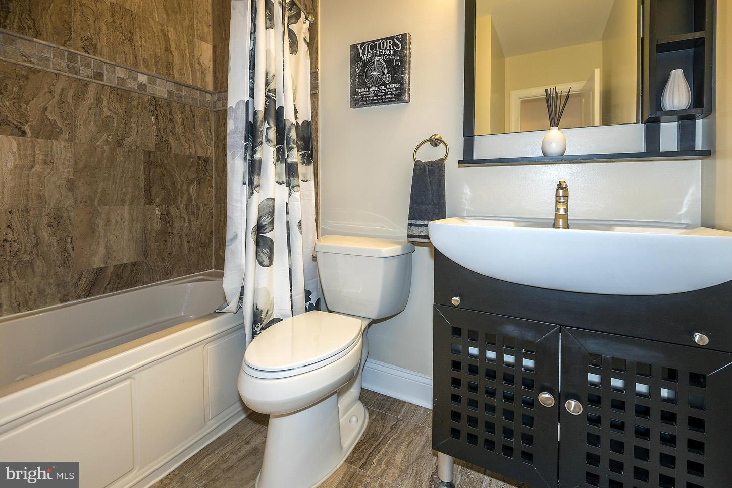 1925 North Capitol Street Northeast, Unit 2 Washington, DC 20002 - Photo 14 of 22 a bathroom with a sink toilet and shower