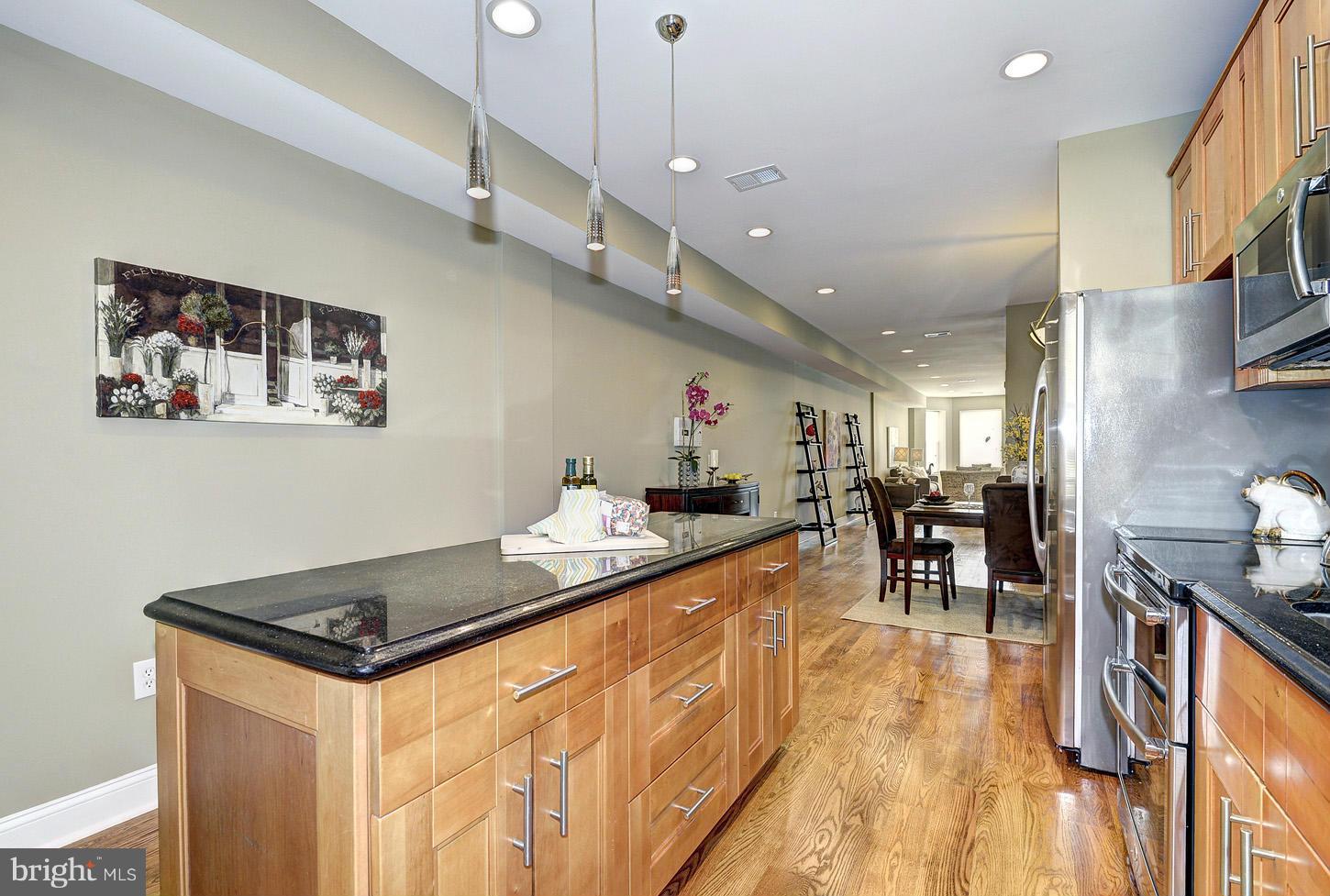 1925 North Capitol Street Northeast, Unit 2 Washington, DC 20002 - Photo 8 of 22 a kitchen with stainless steel appliances granite countertop a stove and a wooden floors