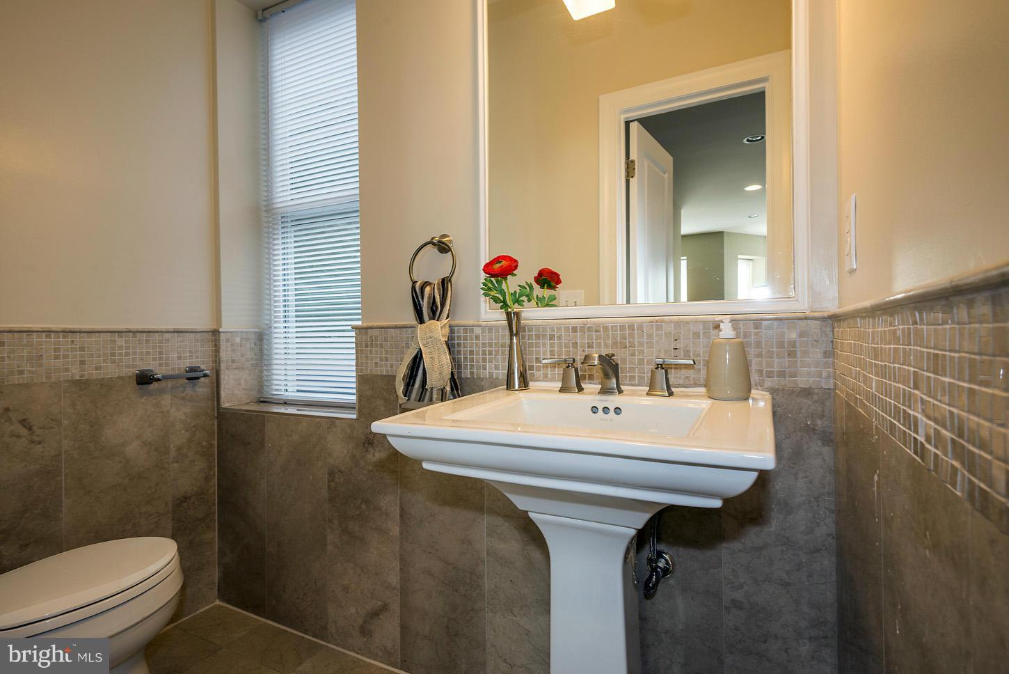 1925 North Capitol Street Northeast, Unit 2 Washington, DC 20002 - Photo 9 of 22 a bathroom with a sink toilet and mirror