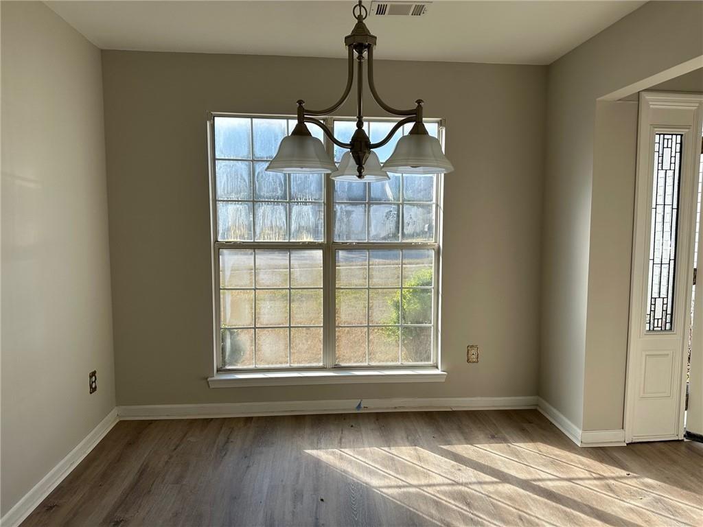 6770 Biscayne Rex, GA 30273 - Photo 12 of 24 a view of an empty room with wooden floor and a window