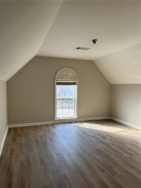 6770 Biscayne Rex, GA 30273 - Photo 13 of 24 an empty room with wooden floor and windows