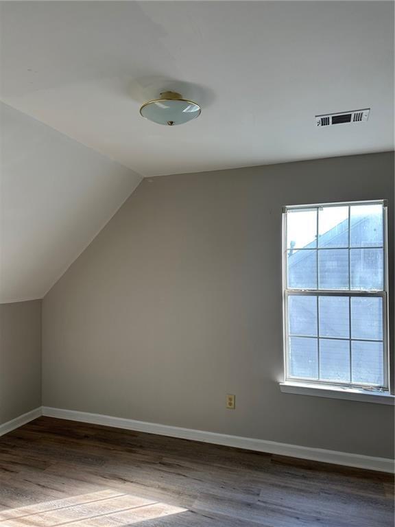 6770 Biscayne Rex, GA 30273 - Photo 16 of 24 an empty room with wooden floor and windows