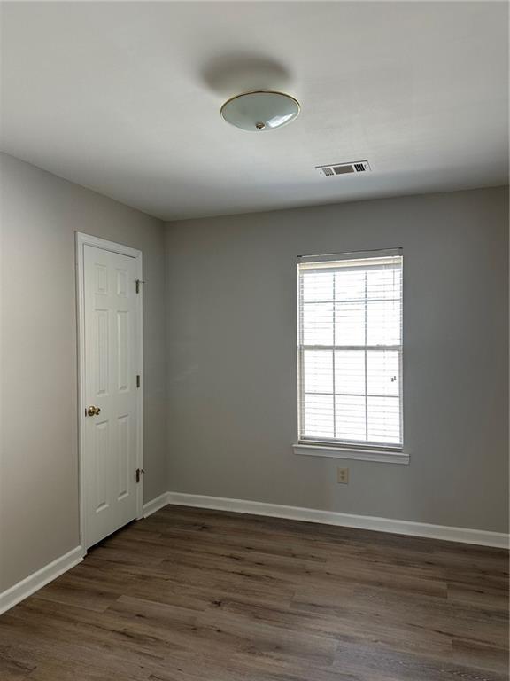 6770 Biscayne Rex, GA 30273 - Photo 20 of 24 an empty room with wooden floor and windows