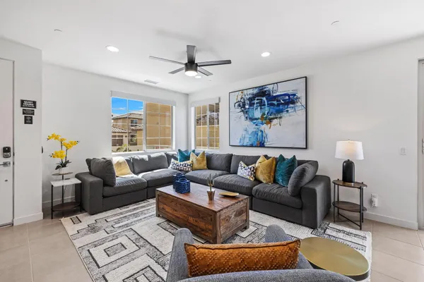 a living room with furniture a couch and a window