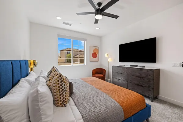 a bedroom with a bed and a window
